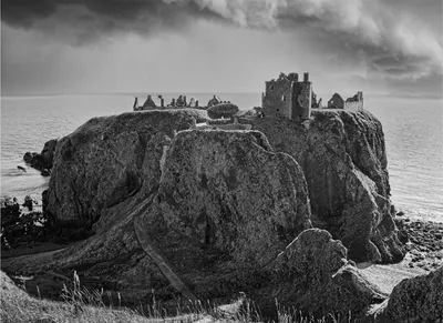 Black and white photograph of Dunnottar Castle on its sea cliff, Scotland